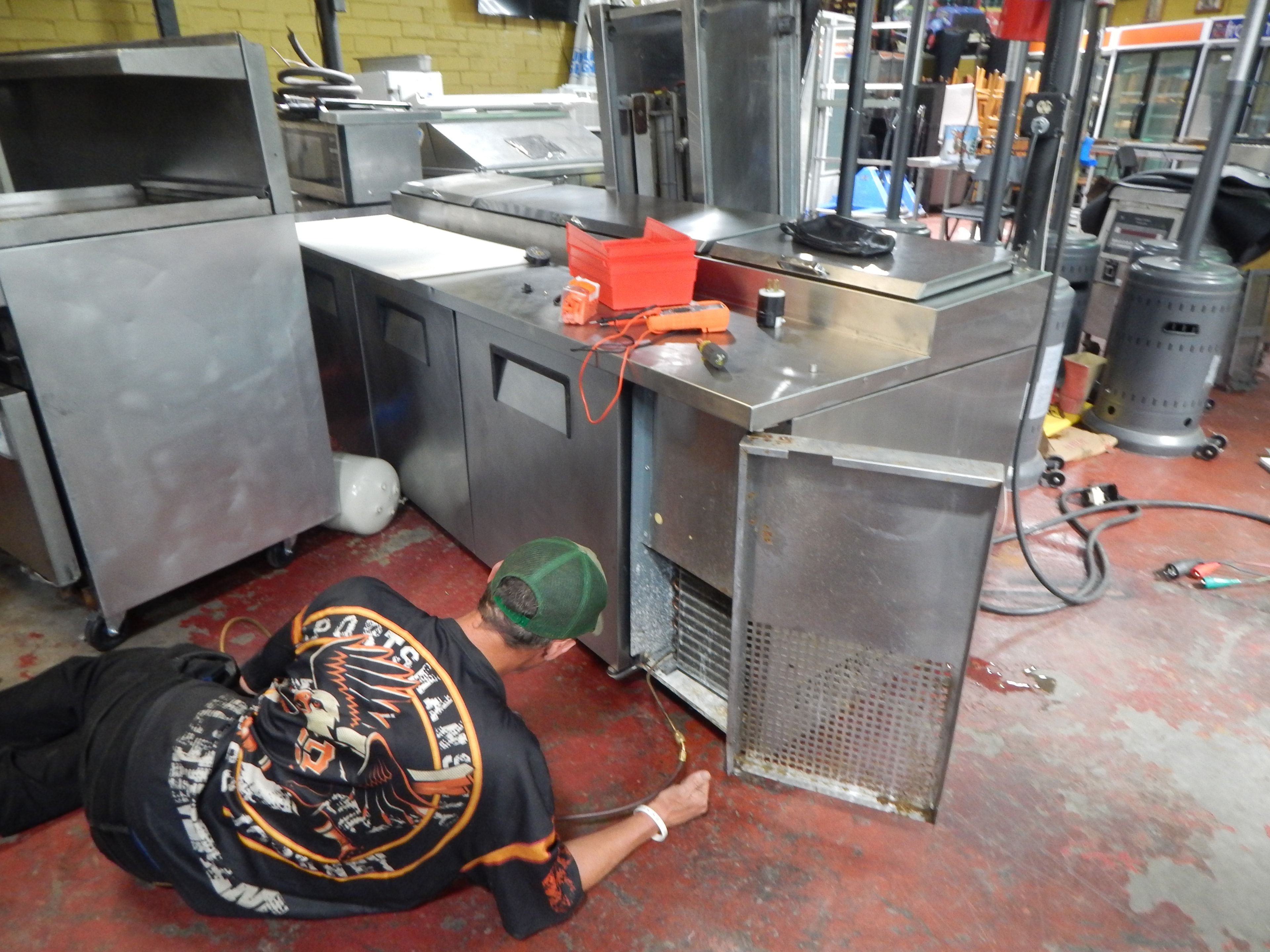 Technician working on commercial kitchen equipment during hands-on training